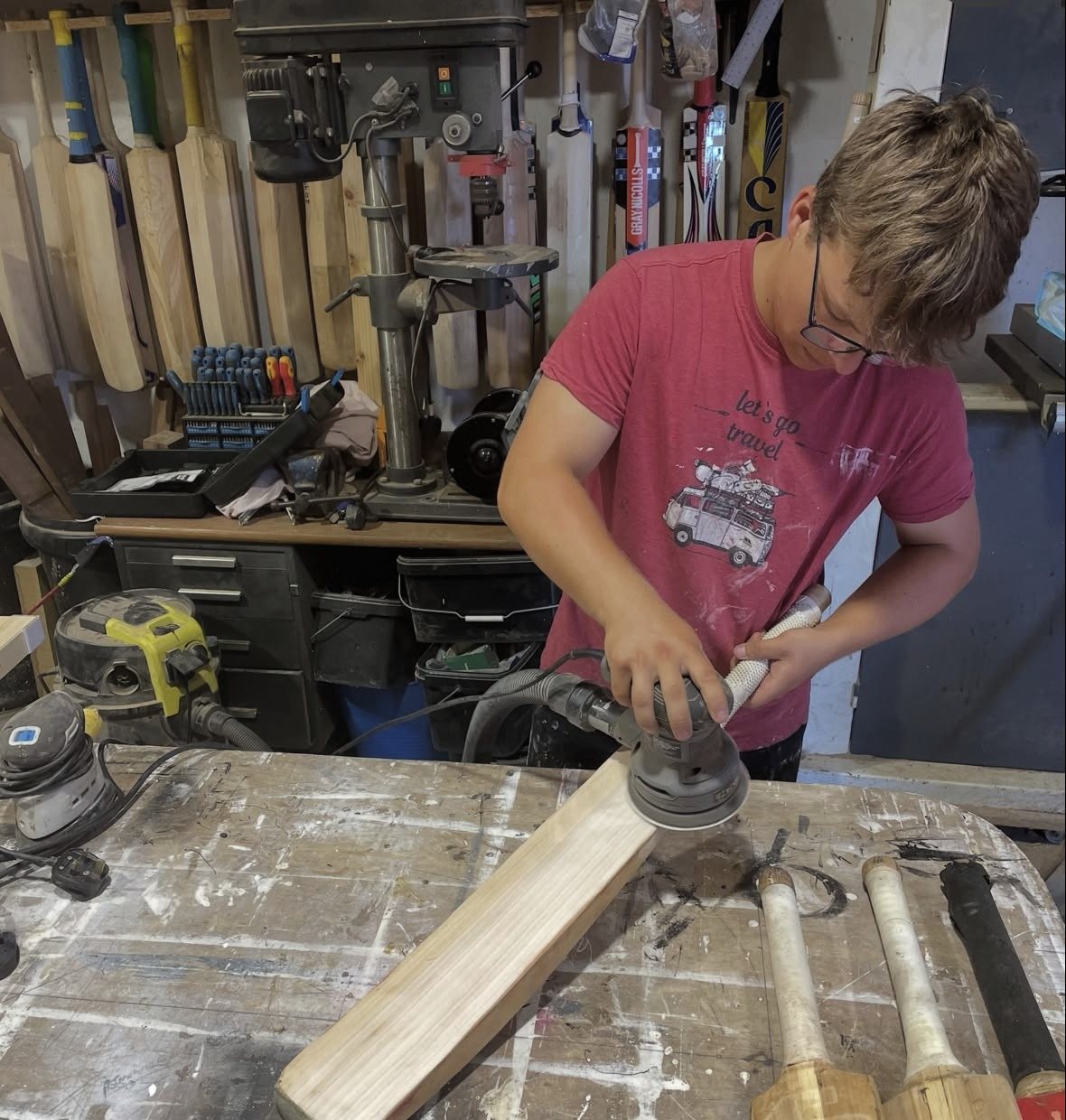 Ben Parsons at work restoring a cricket bat in his workshop